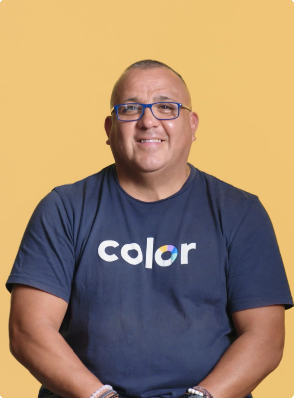 Man with glasses wearing a blue Color shirt smiling