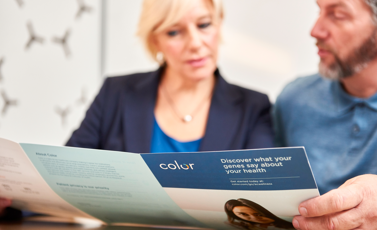 Woman and man reading a Color brochure together