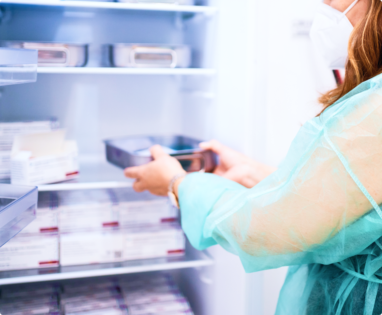 Healthcare professional in a lab holding a tray with supplies