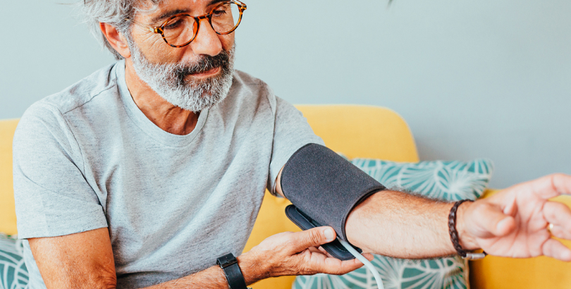 Employee using Color at-home Essential Care Kit to measure blood pressure