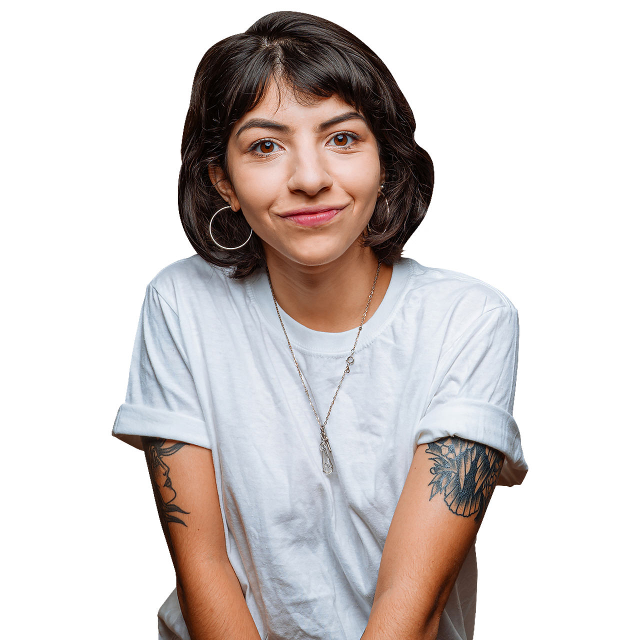 Woman wearing white shirt with tattoos on arms looking at the camera