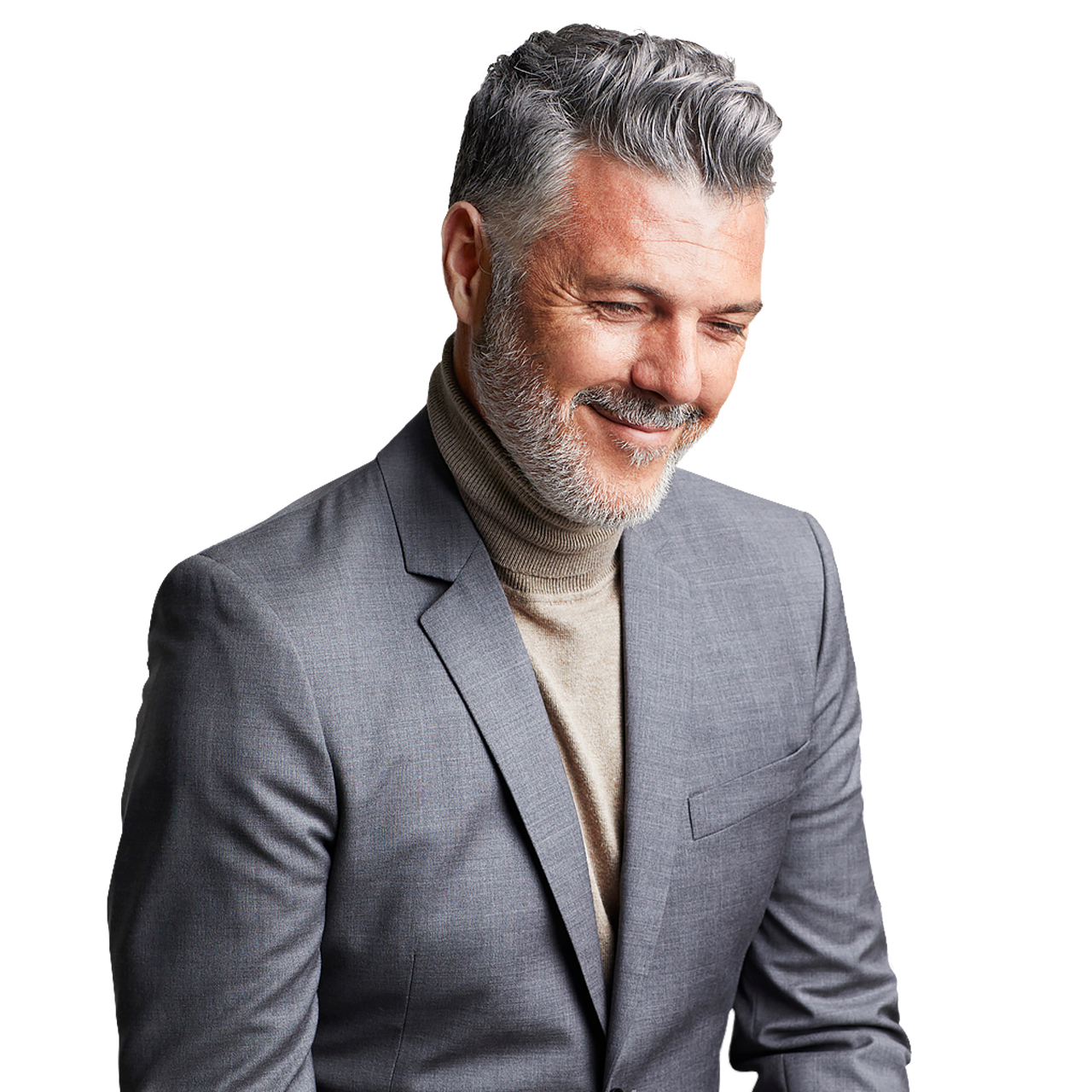 Man wearing turtle neck and grey blazer looking down and smiling