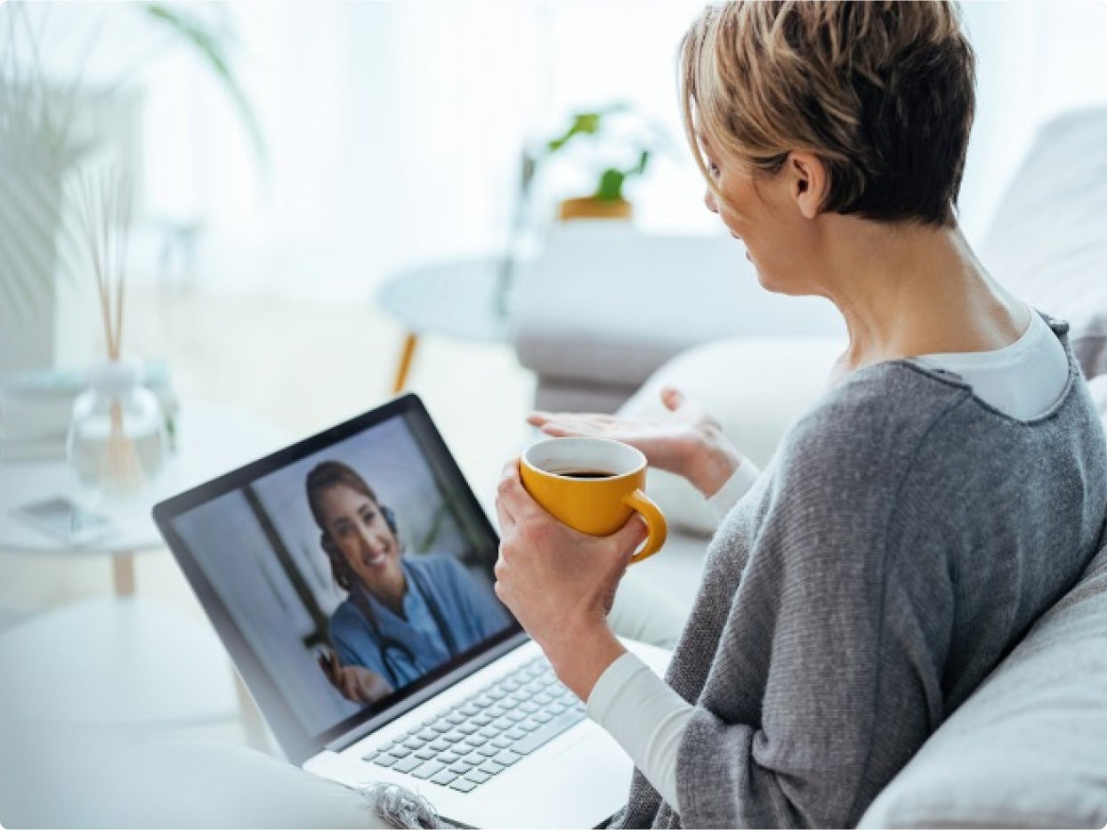 Women with a coffee mug during a telehealth consultation