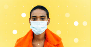 woman in a mask against a polka dot background