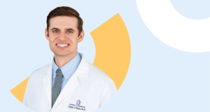 Dr. Dylan O'Shea, Primary Care Provider at Color, smiling in a white coat on a light blue background with abstract yellow and white geometric shapes.